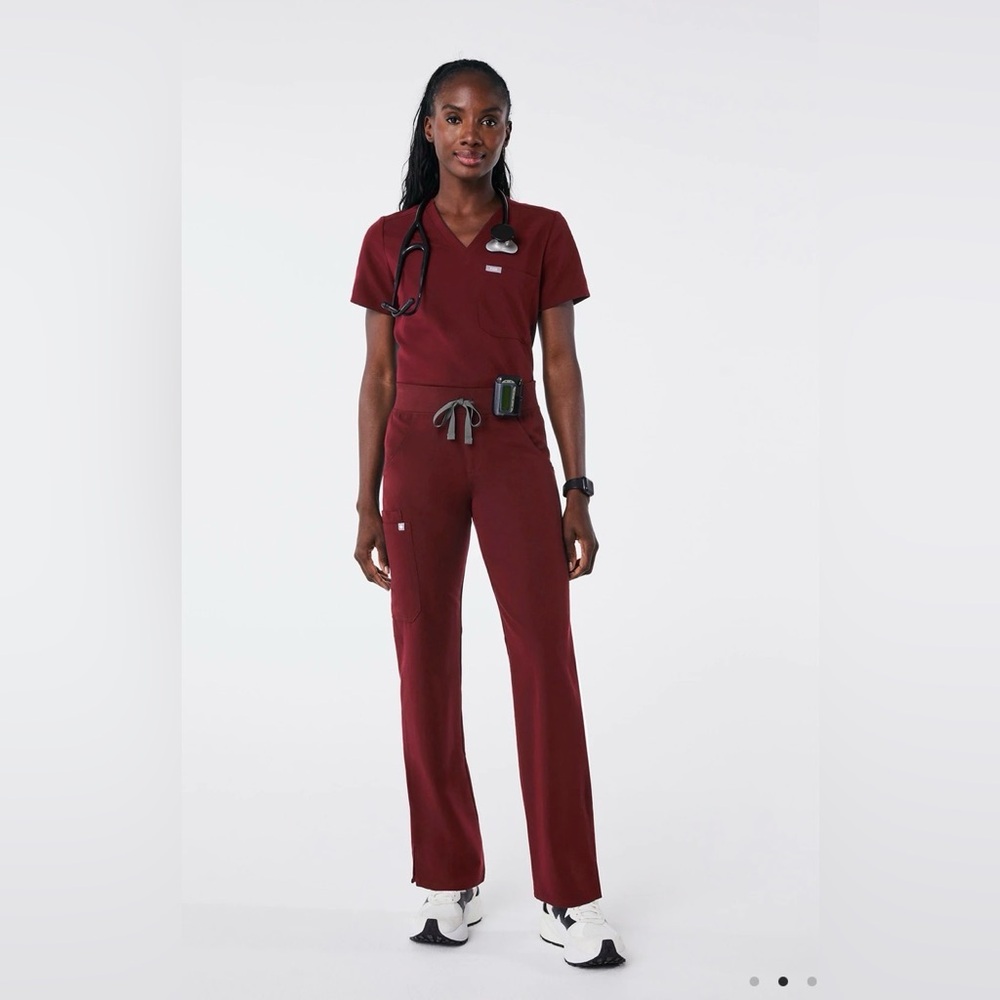 Figs Women's burgundy 3- pocket scrub top.